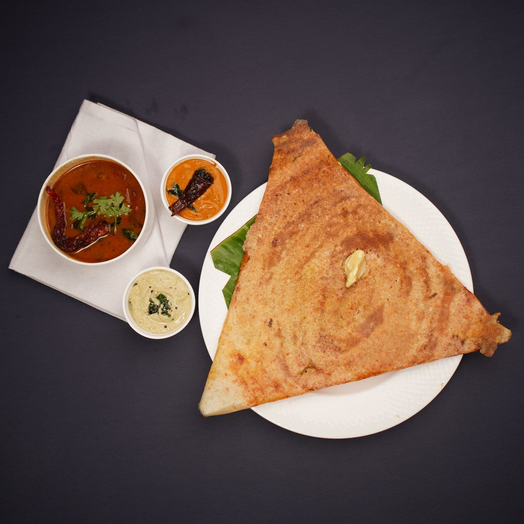 A crisp masala dosa served with chutneys and sambar