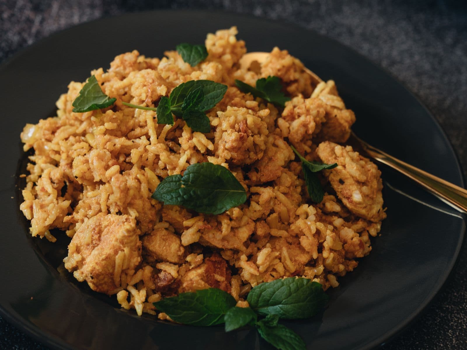 Chicken biryani garnished with mint
