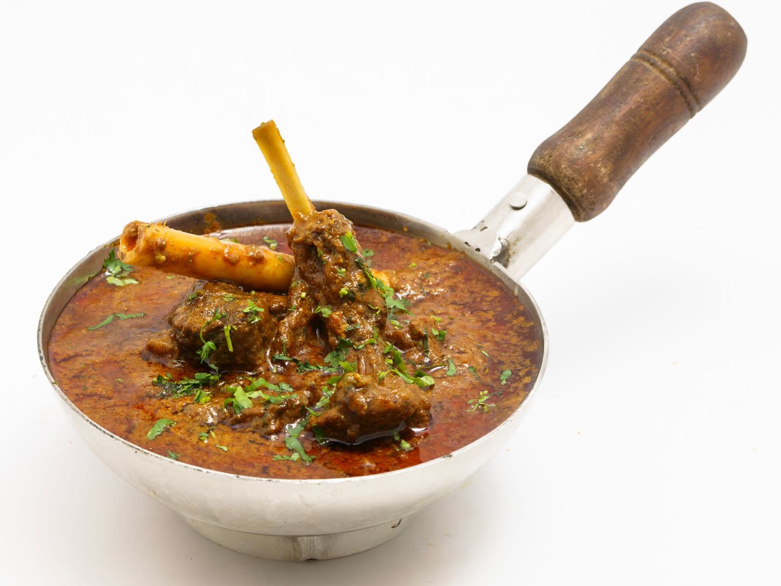 Mutton curry served in a traditional pot