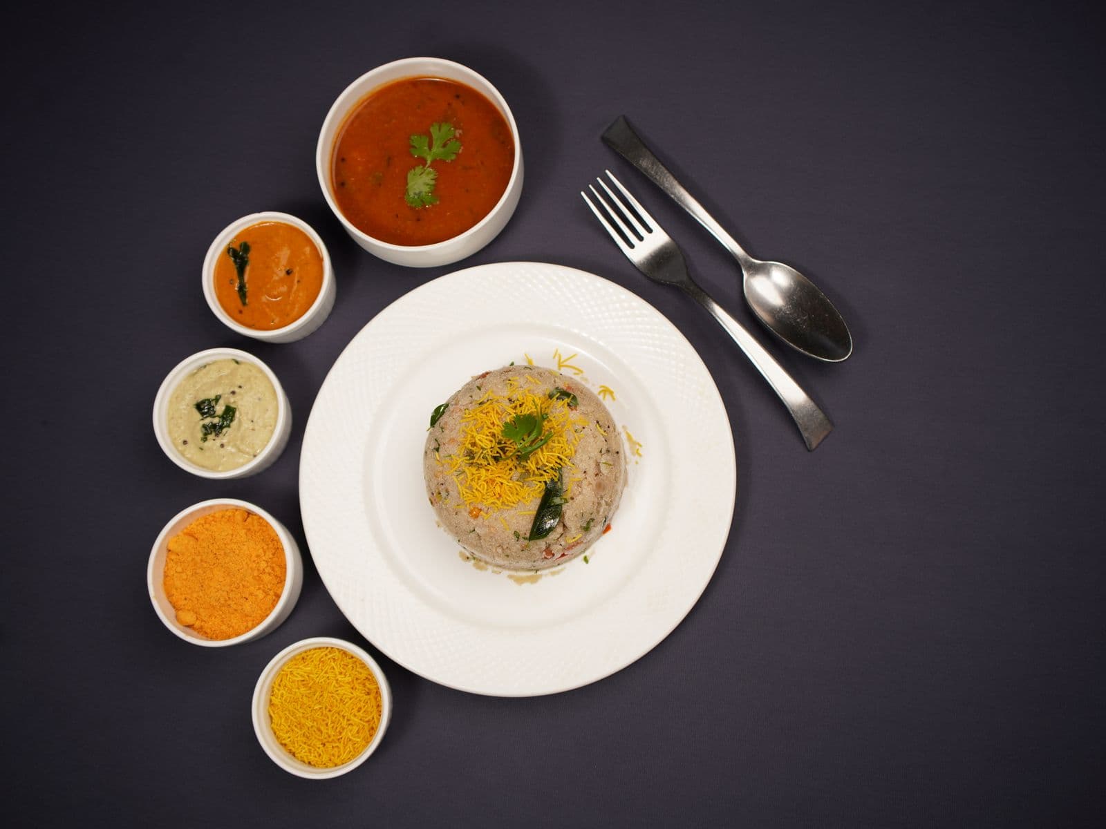Upma served with assorted chutneys